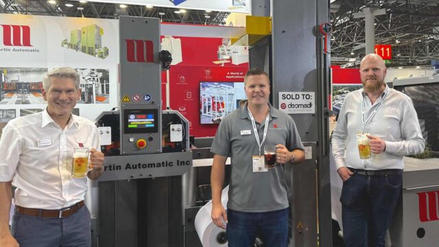 (left to right) Bernd Schopferer and Jordan Martin celebrate the sale of the MBS with Henri Kohler of Desmedt Labels